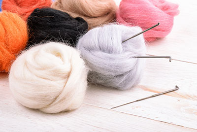 Needle felt – wool and needles close up