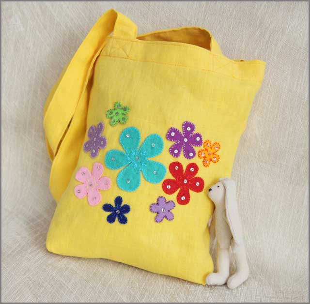 A bright yellow felt tote bag to fit the occasion