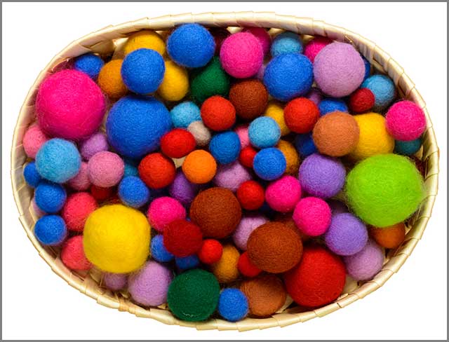 A basket of wool balls of different colors