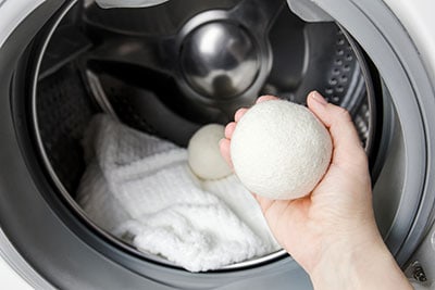 Person using wool dryer balls