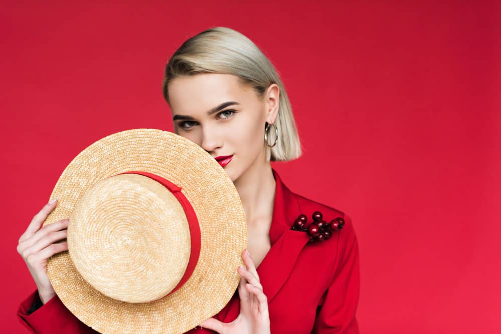 Girl posing with a straw hat